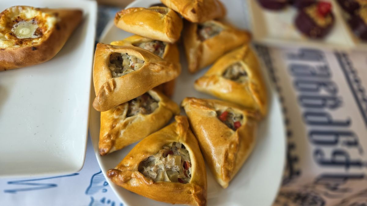 Pastry bites filled with chicken salad on a white plate