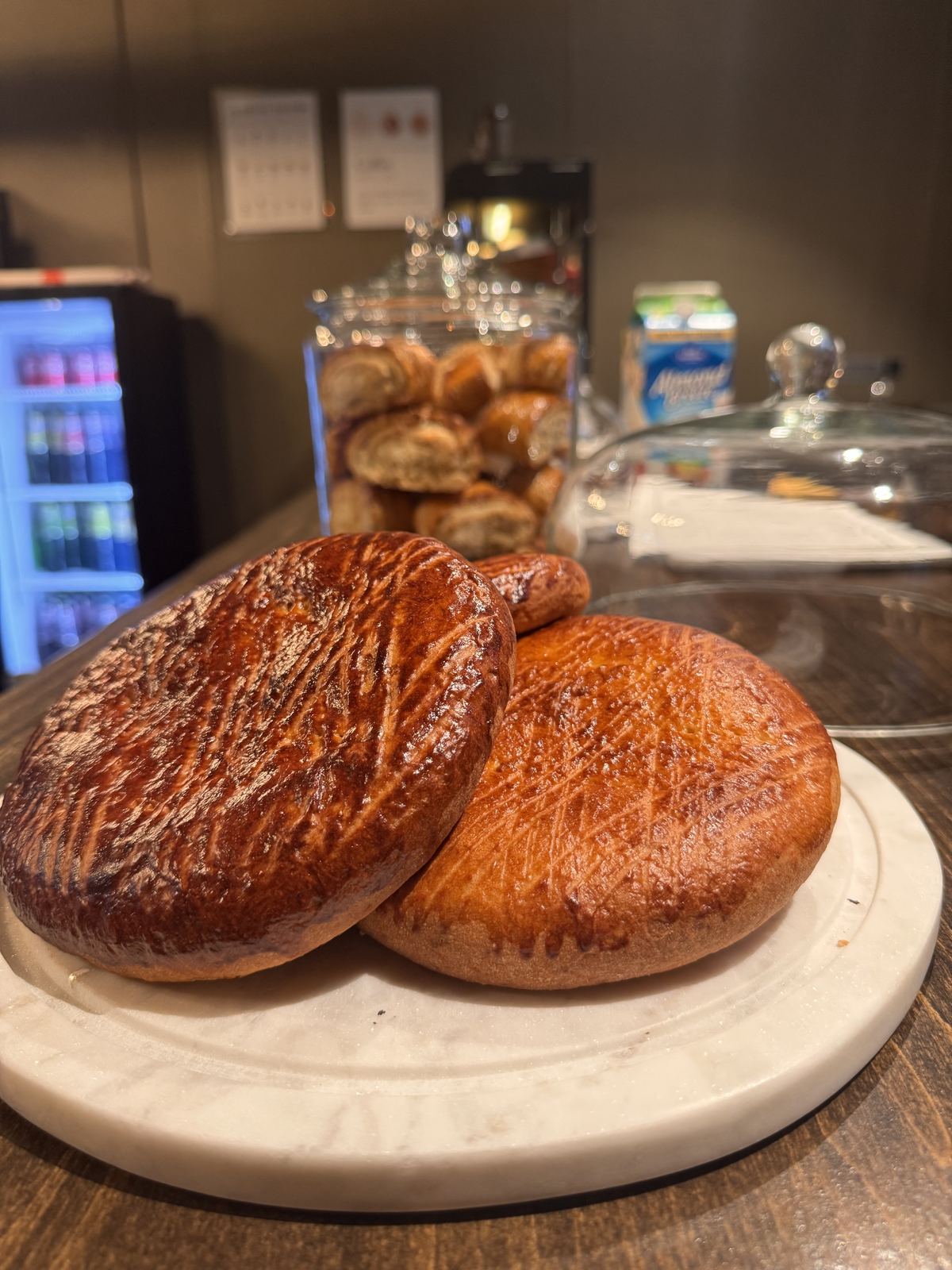Pastries on the counter in front of the display case at Kolhelly Bakery in Brooklyn